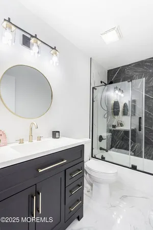 a bathroom with a sink toilet and shower