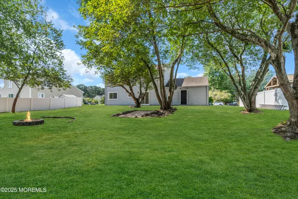 a house with green field in front of it