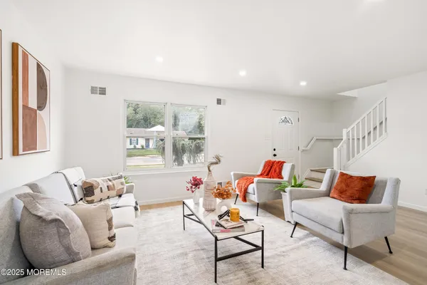 a living room with furniture and a painting