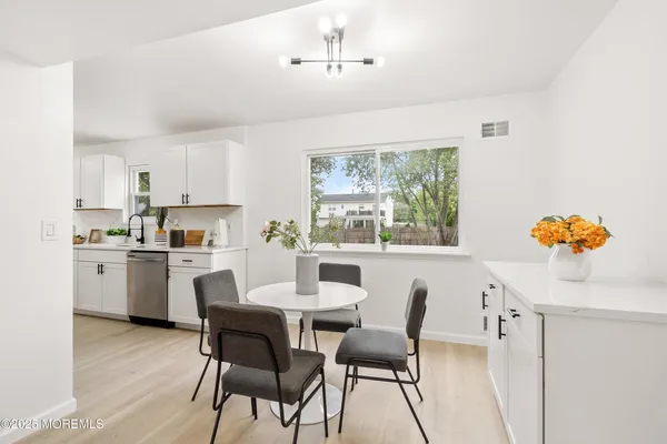 a dining room with furniture a window and kitchen view