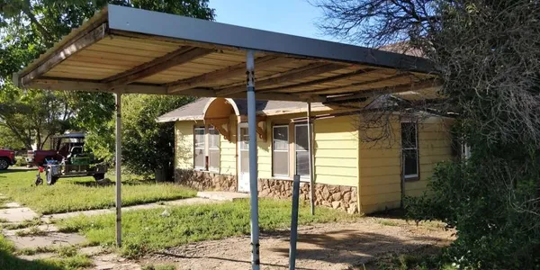 a view of a car park in front of a house