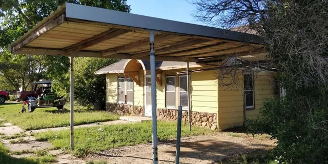 a view of a car park in front of a house
