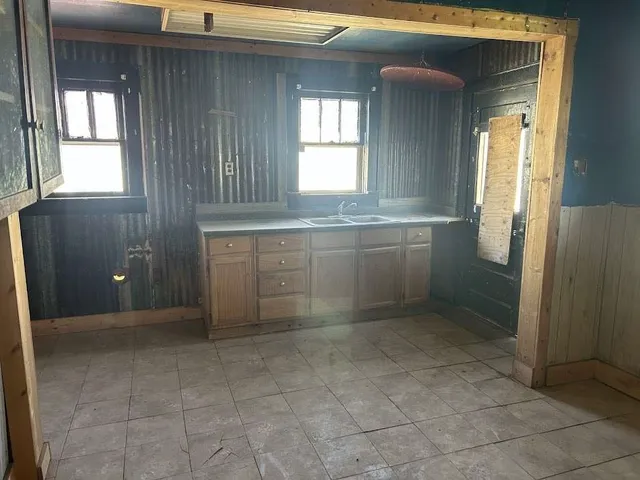 a bathroom with a granite countertop sink a mirror and a bathtub