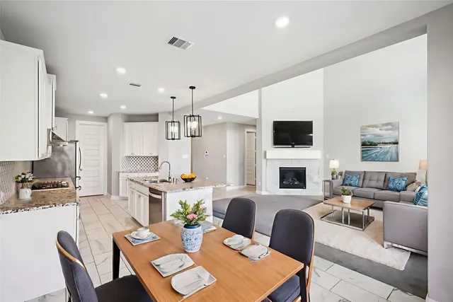 a kitchen with stainless steel appliances granite countertop a refrigerator and a sink