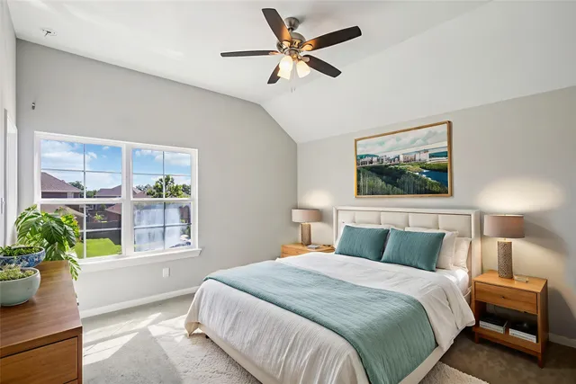 a bedroom with a large bed and a potted plant