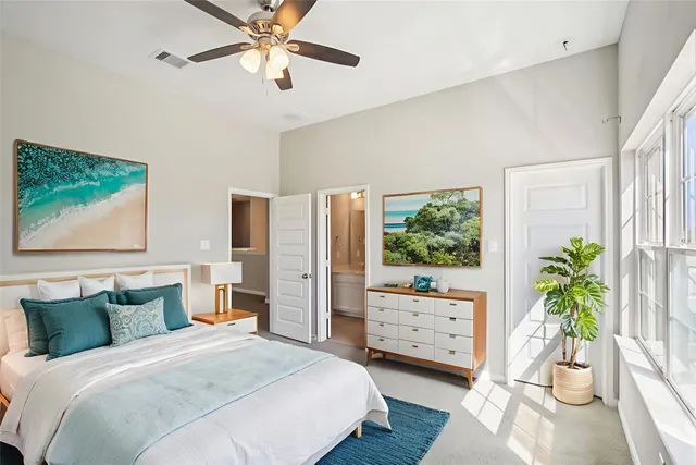 a bedroom with a bed and a potted plant
