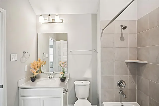 a bathroom with a toilet sink shower and mirror