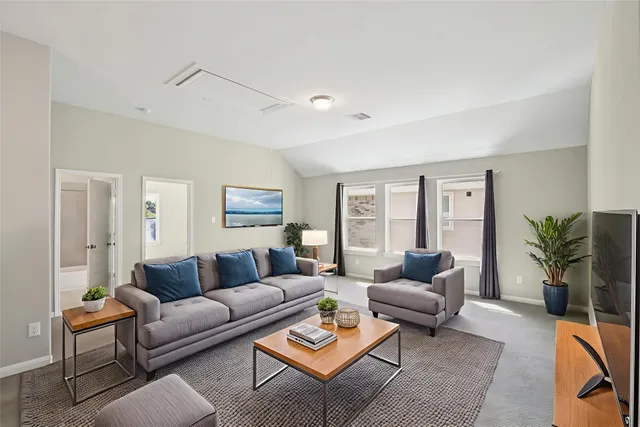 a living room with furniture potted plant and a window
