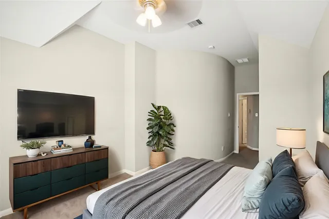 a bedroom with a bed and a flat screen tv