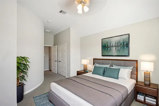 a bedroom with a bed and a painting on the wall