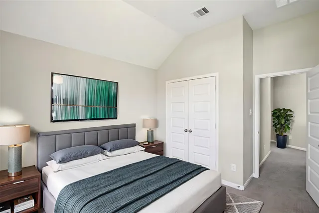 a bedroom with a bed and a lamp