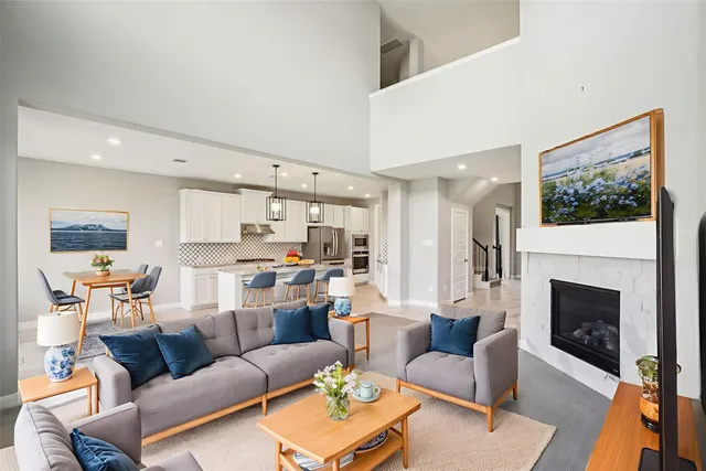 a living room with furniture a large window and a fireplace