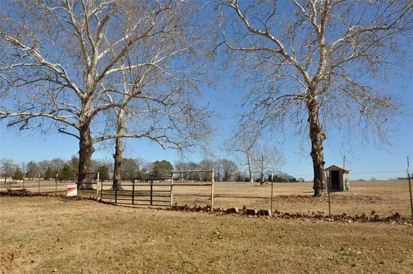 a view of a yard covered with snow in front of house