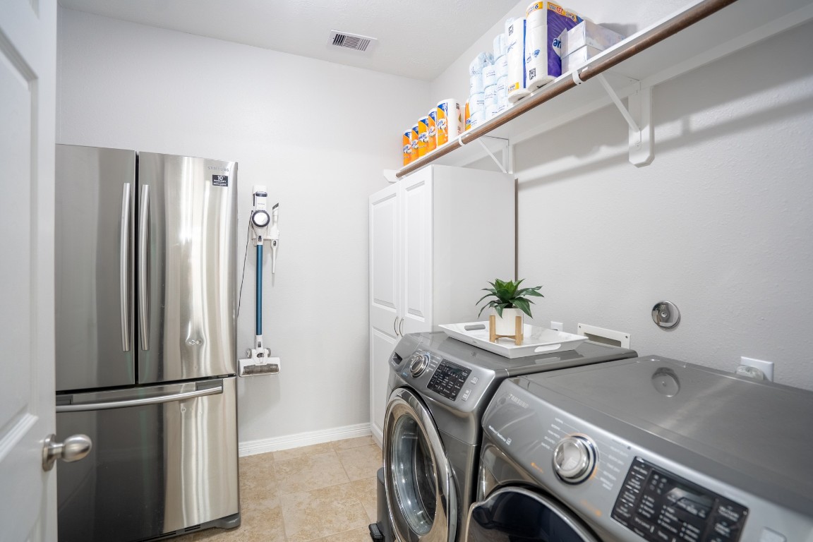 27135 Cottage Stream Lane Fulshear, TX 77441 - Photo 17 of 42 Dedicated laundry room with washer and dryer included, plus this refrigerator will stay, with extra storage and convenience.
