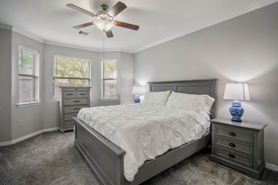 27135 Cottage Stream Lane Fulshear, TX 77441 - Photo 18 of 42 Unwind in this serene primary suite filled with natural light and designed for rest and relaxation.