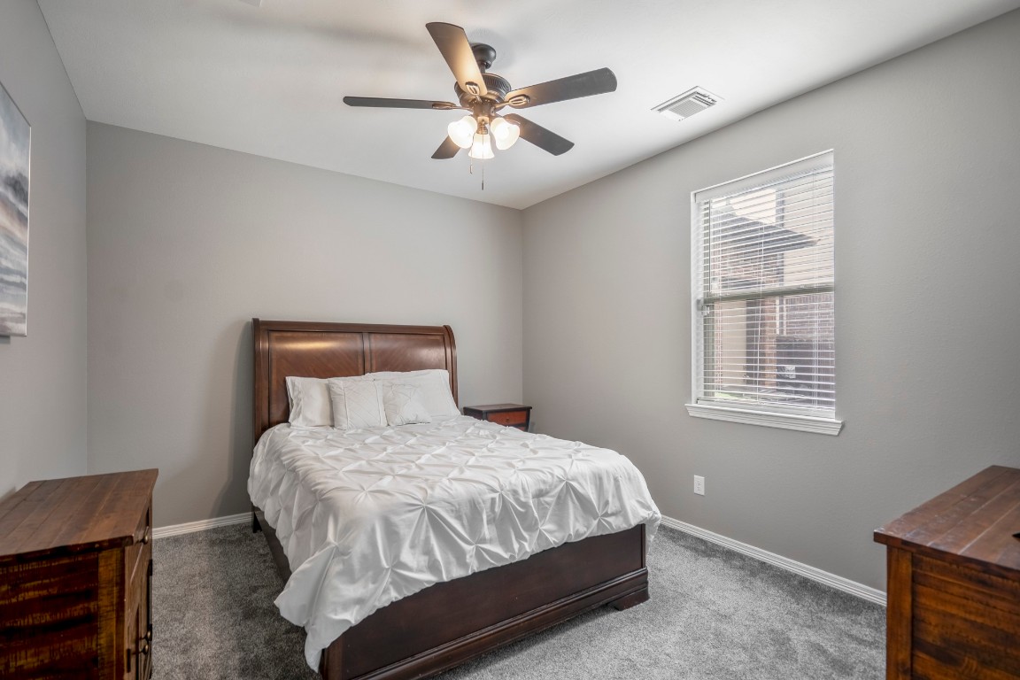 27135 Cottage Stream Lane Fulshear, TX 77441 - Photo 25 of 42 Comfortable secondary bedroom filled with natural light - ideal for guests or family.