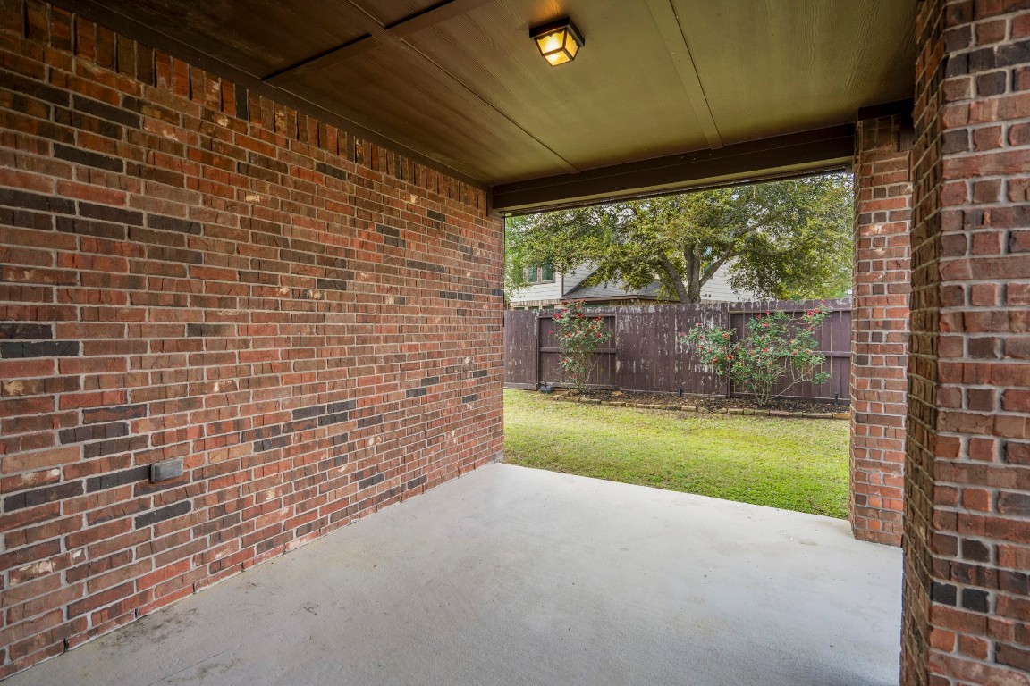 27135 Cottage Stream Lane Fulshear, TX 77441 - Photo 28 of 42 Covered patio overlooking the backyard - perfect for outdoor dining, relaxing and year-round enjoyment.