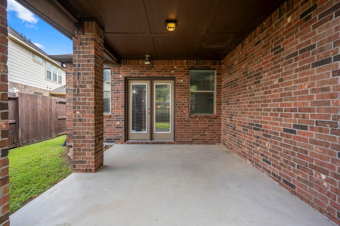 27135 Cottage Stream Lane Fulshear, TX 77441 - Photo 29 of 42 Spacious covered patio with easy access to the home - perfect for indoor-outdoor living and entertainment.