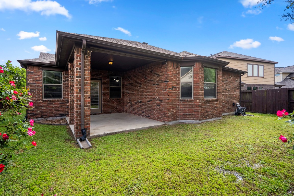 27135 Cottage Stream Lane Fulshear, TX 77441 - Photo 30 of 42 Covered back patio overlooking a spacious backyard - perfect for outdoor living, relaxing or entertaining.