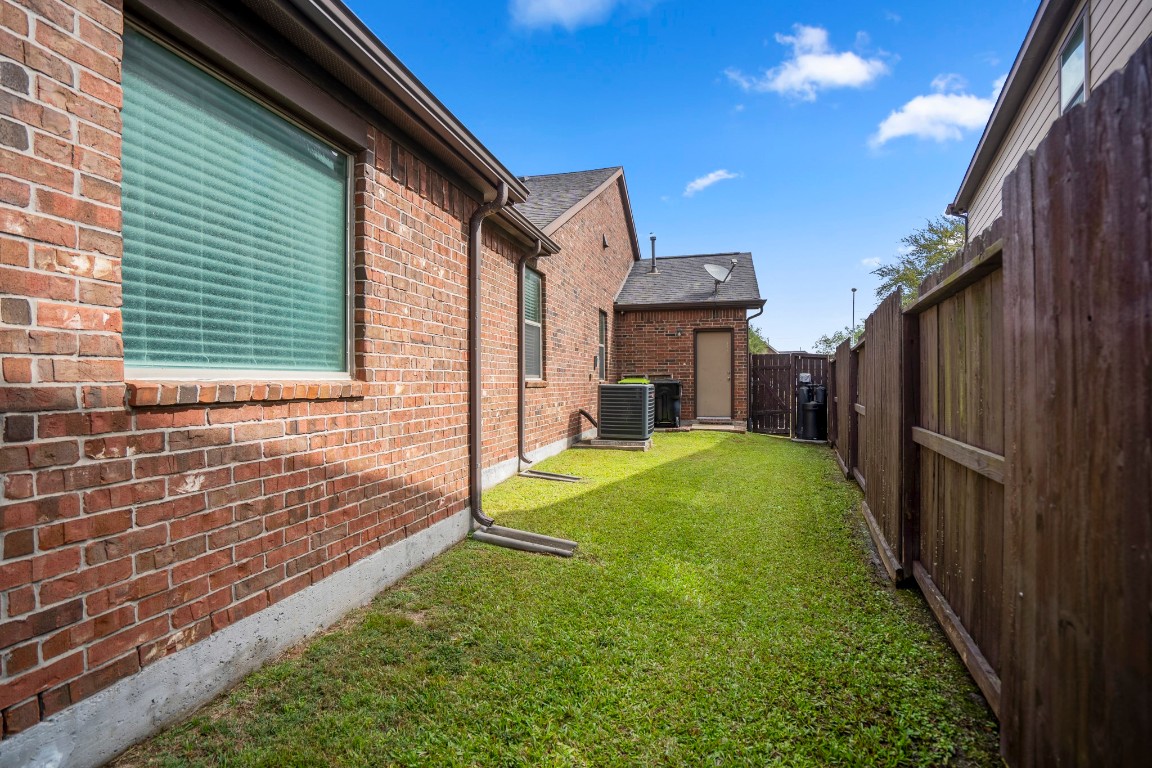 27135 Cottage Stream Lane Fulshear, TX 77441 - Photo 32 of 42 Spacious side with green space and convenient access to the HVAC and utilities and a door from the garage.