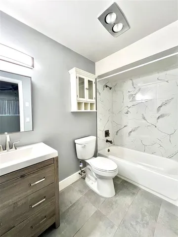 a bathroom with a toilet a sink and a bathtub