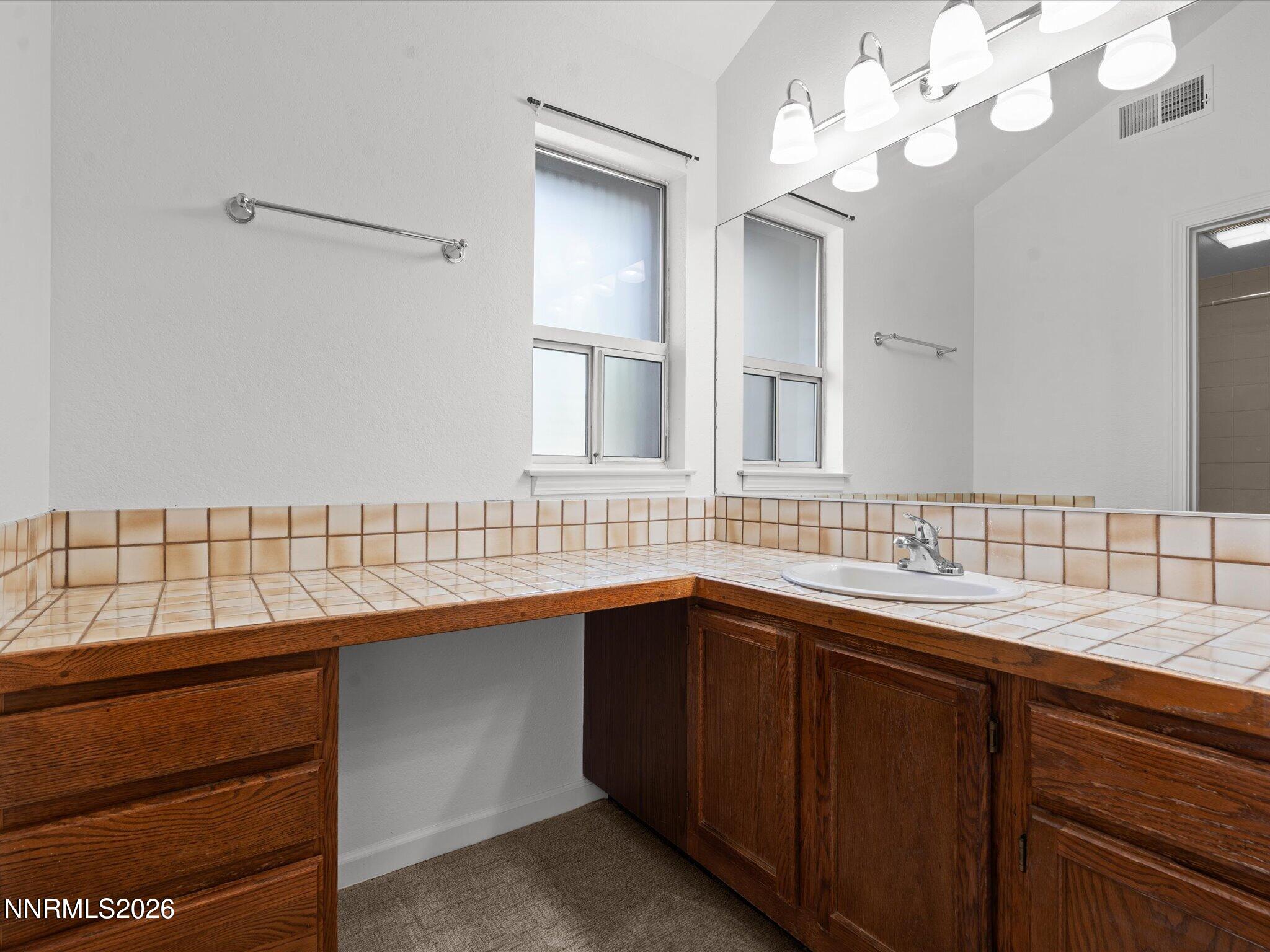3170 Oakshire Court Reno, NV 89509 - Photo 28 of 43 a bathroom with a sink double vanity and a mirror