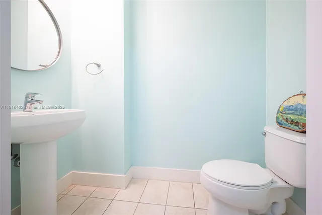 a bathroom with a sink toilet and a mirror