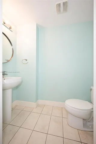 a bathroom with a toilet a sink a vanity and mirror