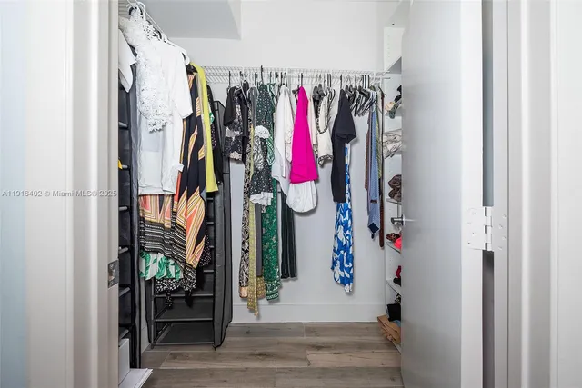 a view of walk in closet with clothes