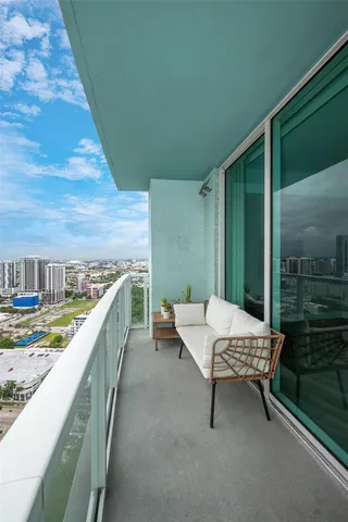 a balcony with chairs and wooden fence