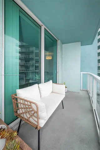 a balcony with table and chairs