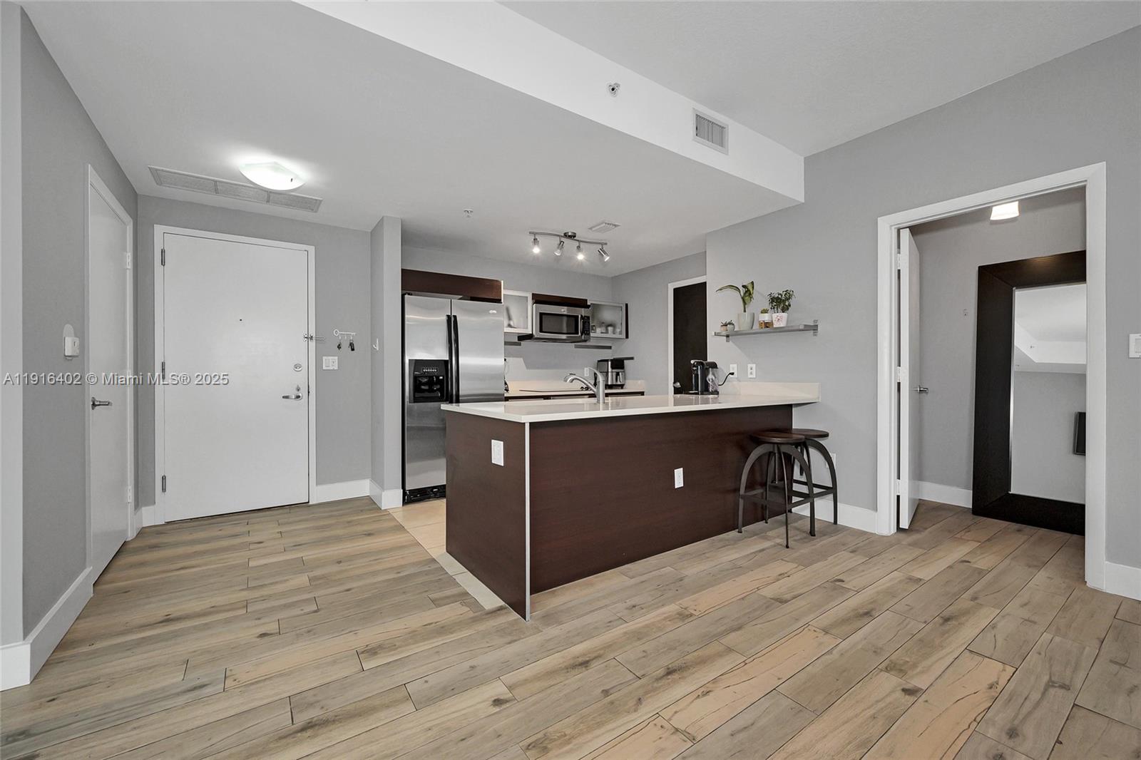 1900 North Bayshore Drive, Unit 4019 Miami, FL 33132 - Photo 5 of 31 a room with a dresser and a refrigerator