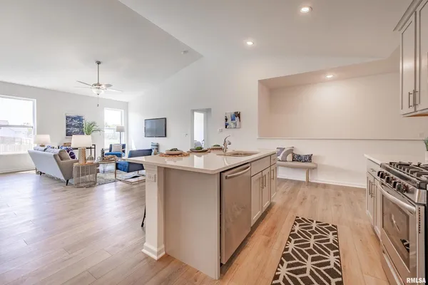 a very nice looking living room with wooden floor and furniture