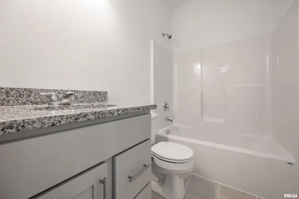 a bathroom with a toilet a sink and bathtub