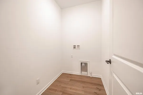 a view of a room with wooden floor