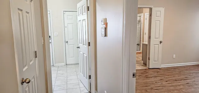 a view of a hallway with windows and stairs