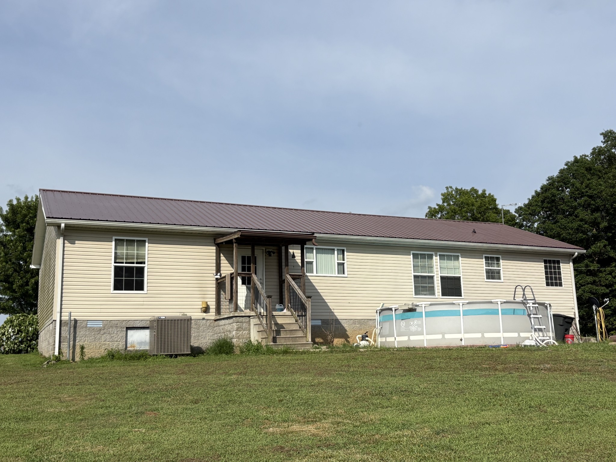 239 Calvert Ridge Road Westmoreland, TN 37186 - Photo 8 of 27 a view of a house with a big yard and a large tree