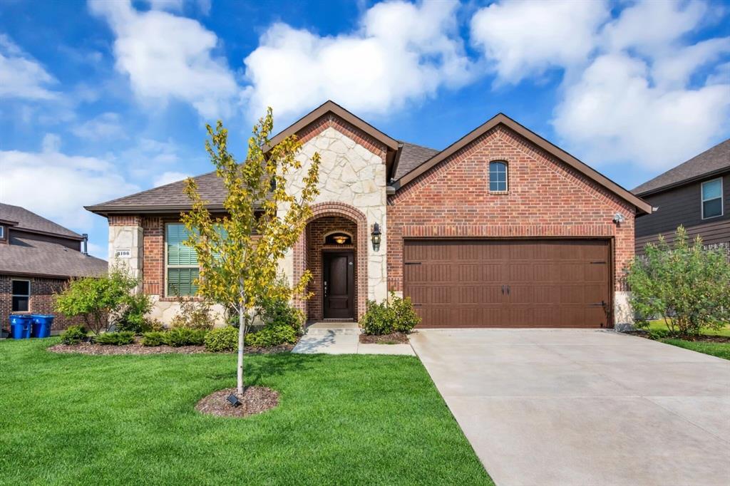 3106 Maverick Drive Forney, TX 75126 - Photo 4 of 32 a front view of a house with a yard and garage