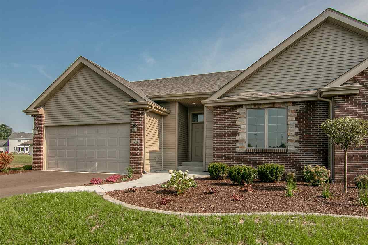 313 East Pershing Road Stillman Valley, IL 61084 - Photo 1 of 21 a front view of a house with garden