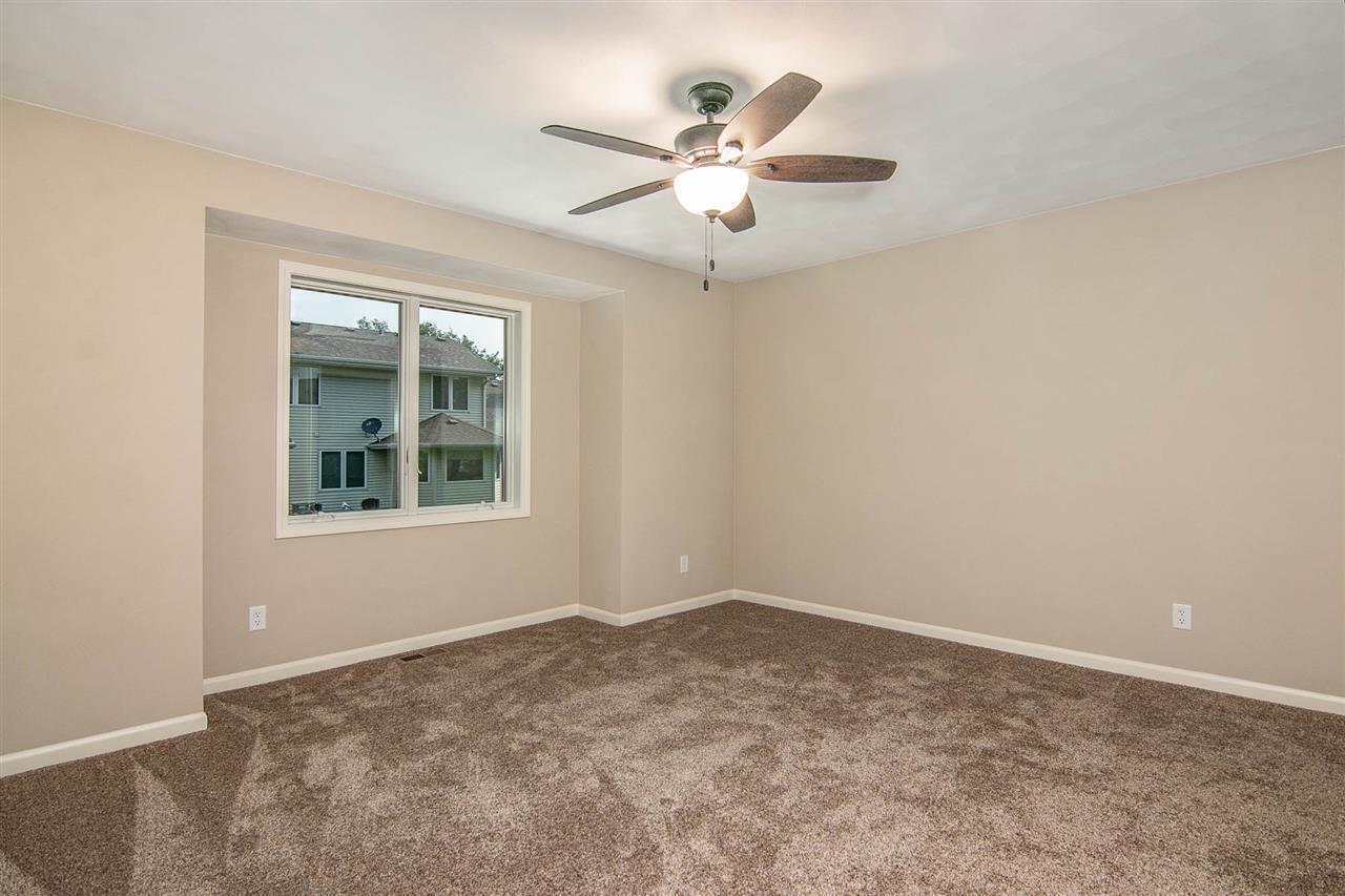 313 East Pershing Road Stillman Valley, IL 61084 - Photo 15 of 21 an empty room with a window and a fan