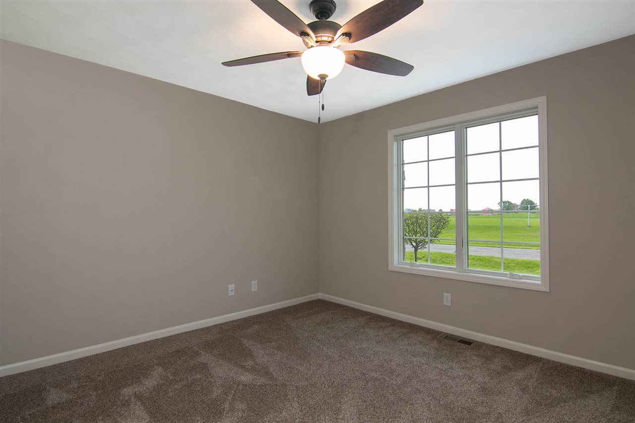 313 East Pershing Road Stillman Valley, IL 61084 - Photo 18 of 21 an empty room with a window and a fan