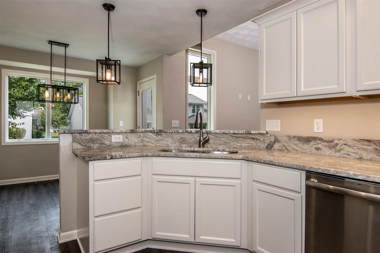 313 East Pershing Road Stillman Valley, IL 61084 - Photo 4 of 21 a kitchen with granite countertop white cabinets and white appliances