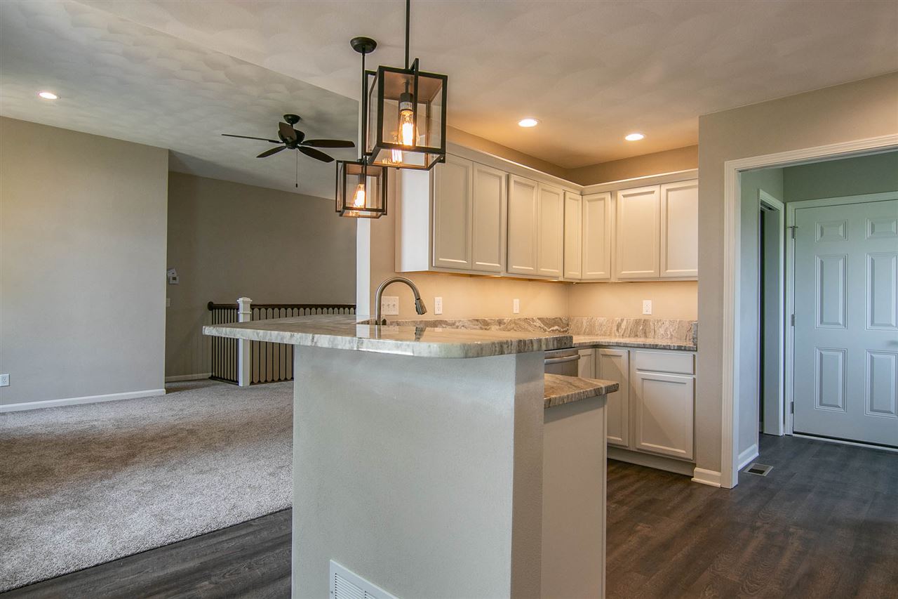 313 East Pershing Road Stillman Valley, IL 61084 - Photo 6 of 21 a kitchen with stainless steel appliances granite countertop a sink stove and refrigerator