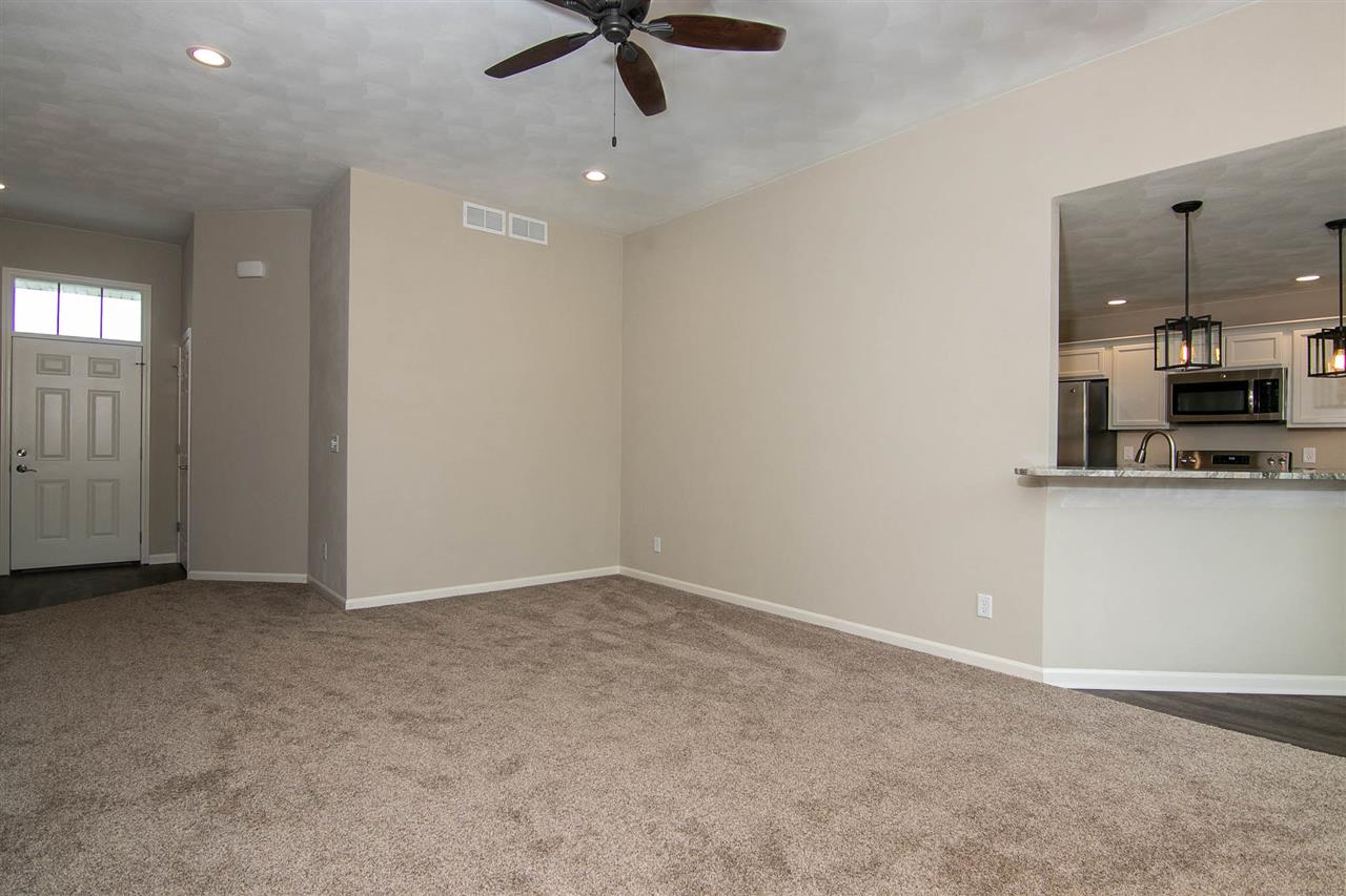 313 East Pershing Road Stillman Valley, IL 61084 - Photo 10 of 21 an empty room with kitchen view and a window