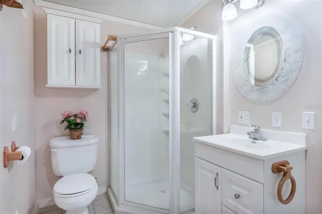 a bathroom with a toilet a sink and a mirror