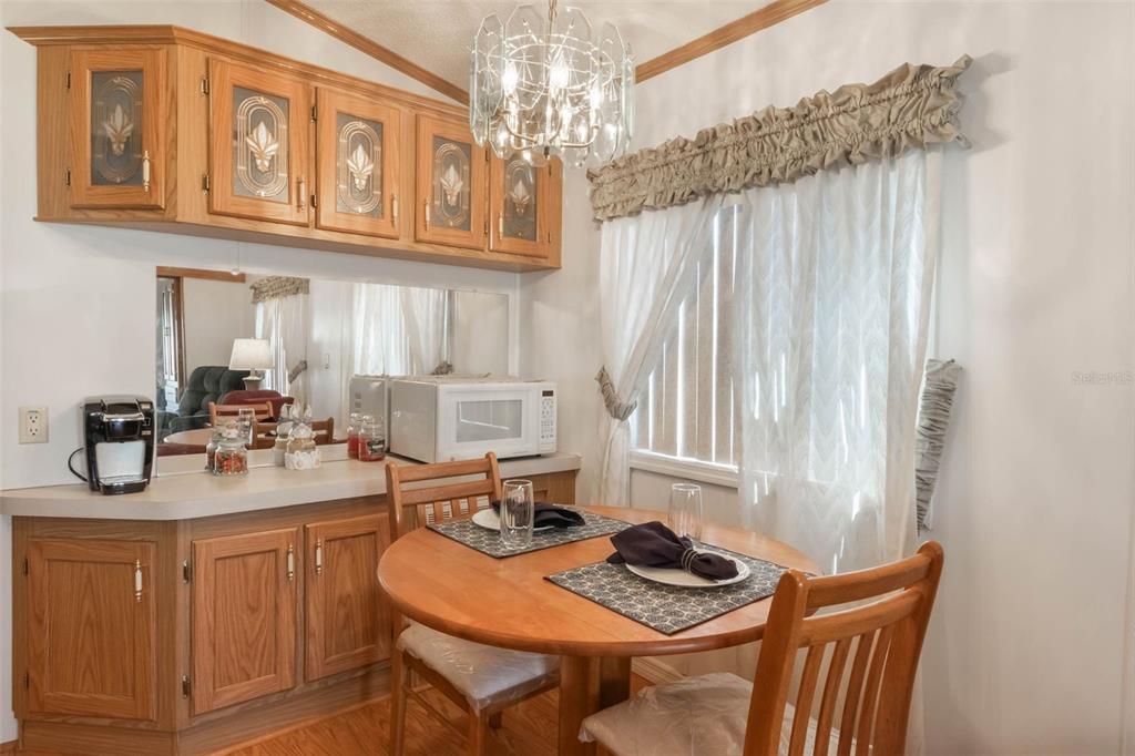 7723 Golf Boulevard Zolfo Springs, FL 33890 - Photo 7 of 24 a kitchen with stainless steel appliances kitchen island a table and chairs in it