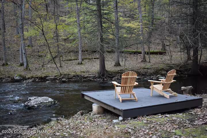 275 Canterbury Road Bushkill, PA 18324 - Photo 3 of 28 a view of a deck with table and chairs and wooden floor