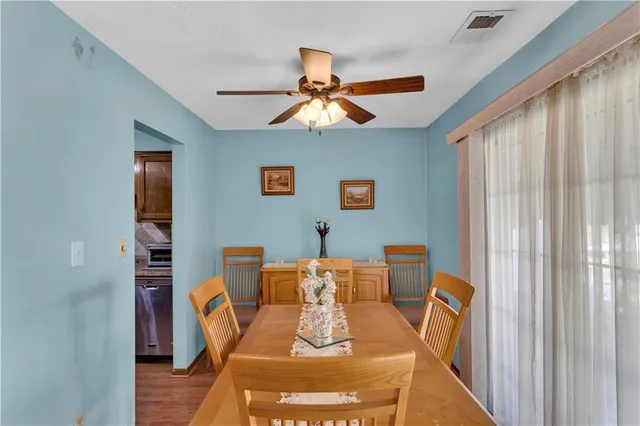 a kitchen with granite countertop a sink stainless steel appliances and cabinets