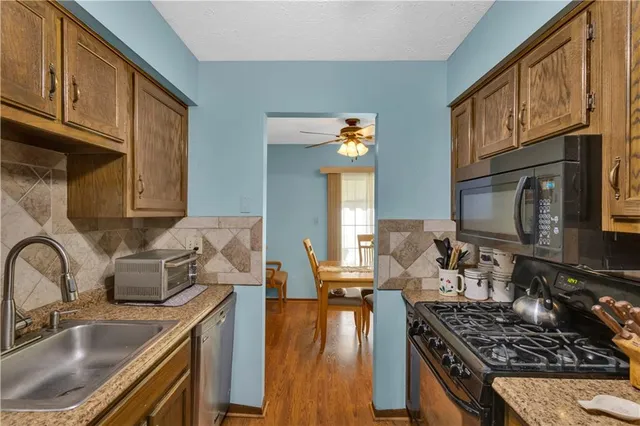 a kitchen with sink refrigerator and cabinets
