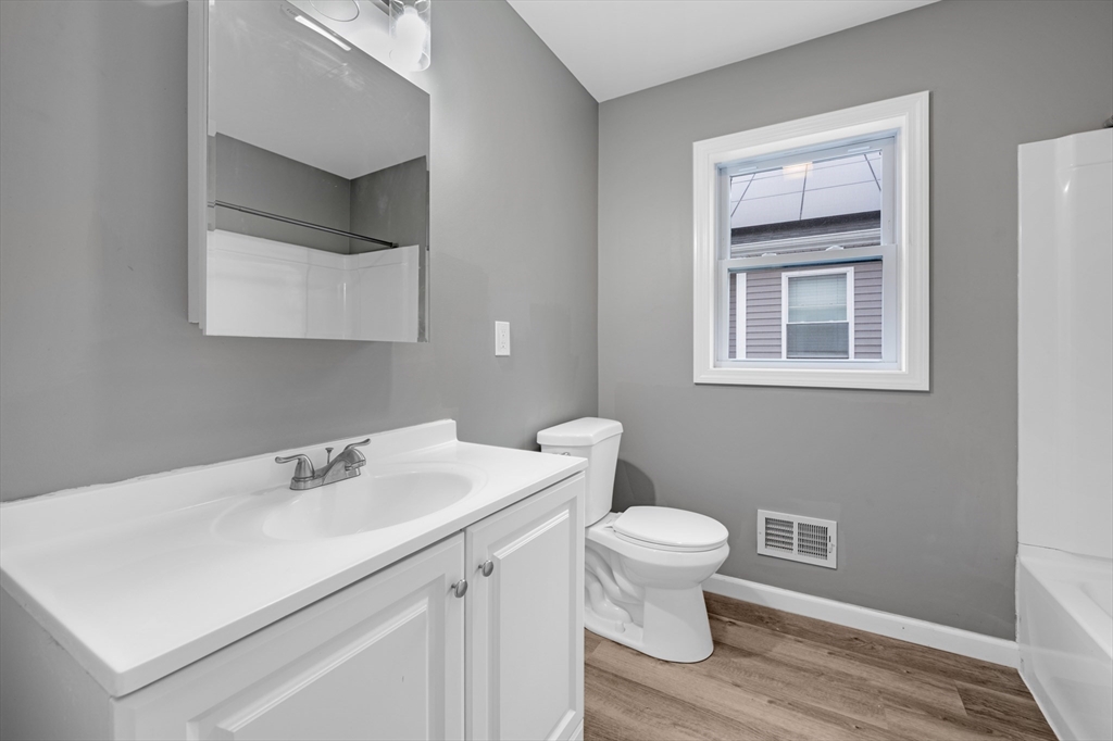 91-93 Alderman Street Springfield, MA 01108 - Photo 13 of 30 a bathroom with a sink toilet and vanity